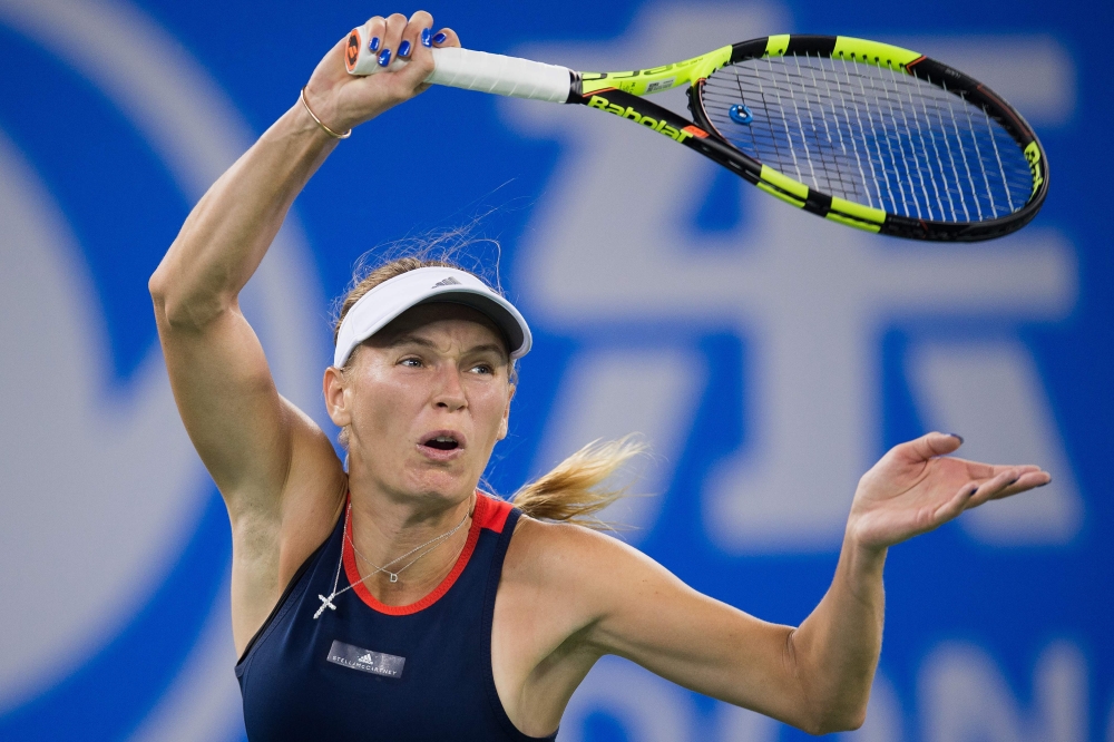 Caroline Wozniacki of Denmark hits a return against Rebecca Peterson of Sweden during their women's singles third round match of the WTA Wuhan Open tennis tournament in Wuhan on September 25, 2018. / AFP / NICOLAS ASFOURI 