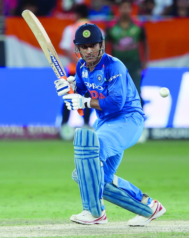 Indian batsman Mahendra Singh Dhoni plays a shot during the final one day international (ODI) Asia Cup cricket match between Bangladesh and India at the Dubai International Cricket Stadium in Dubai on September 28, 2018.  AFP / Ishara S. Kodikara

