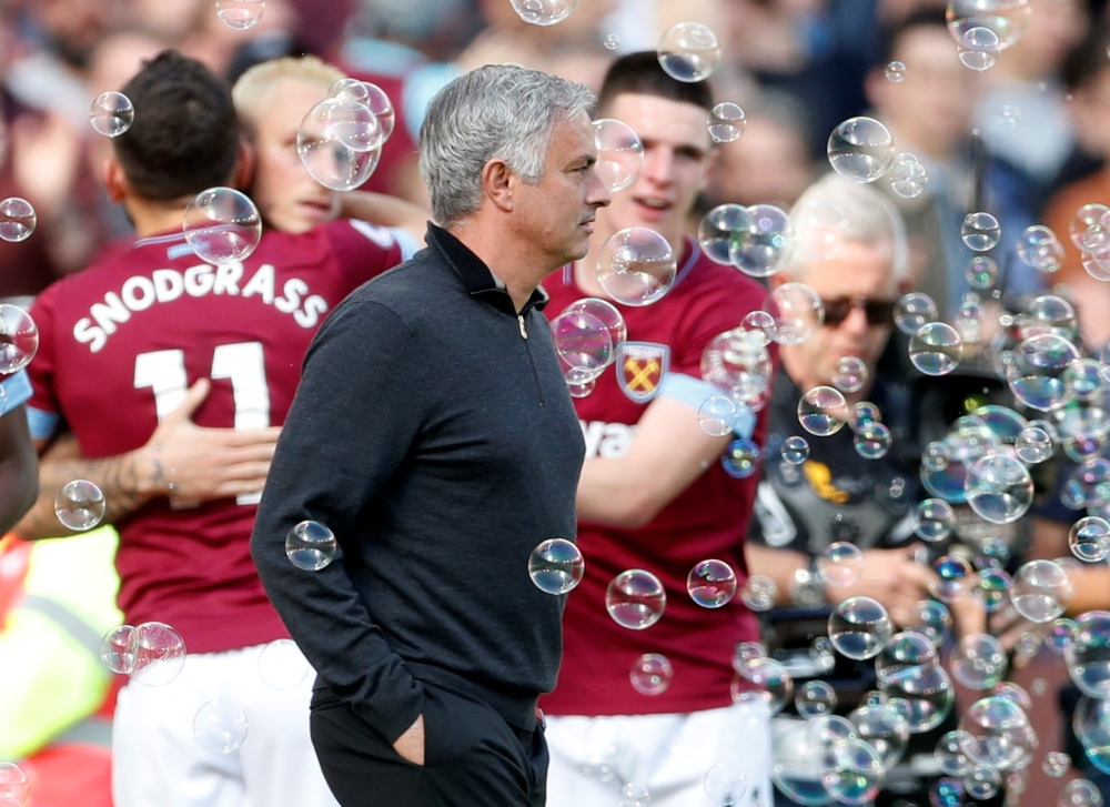 Manchester United manager Jose Mourinho looks dejected as West Ham players celebrate their third goal Action Images via Reuters/Matthew Childs 