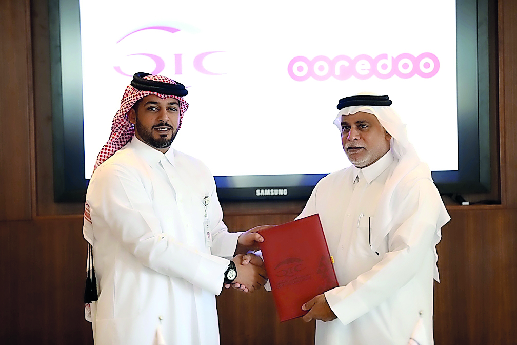 The officials of QIC Group & Ooredoo during the signing of the partnership agreement at QIC headquarters in West Bay.