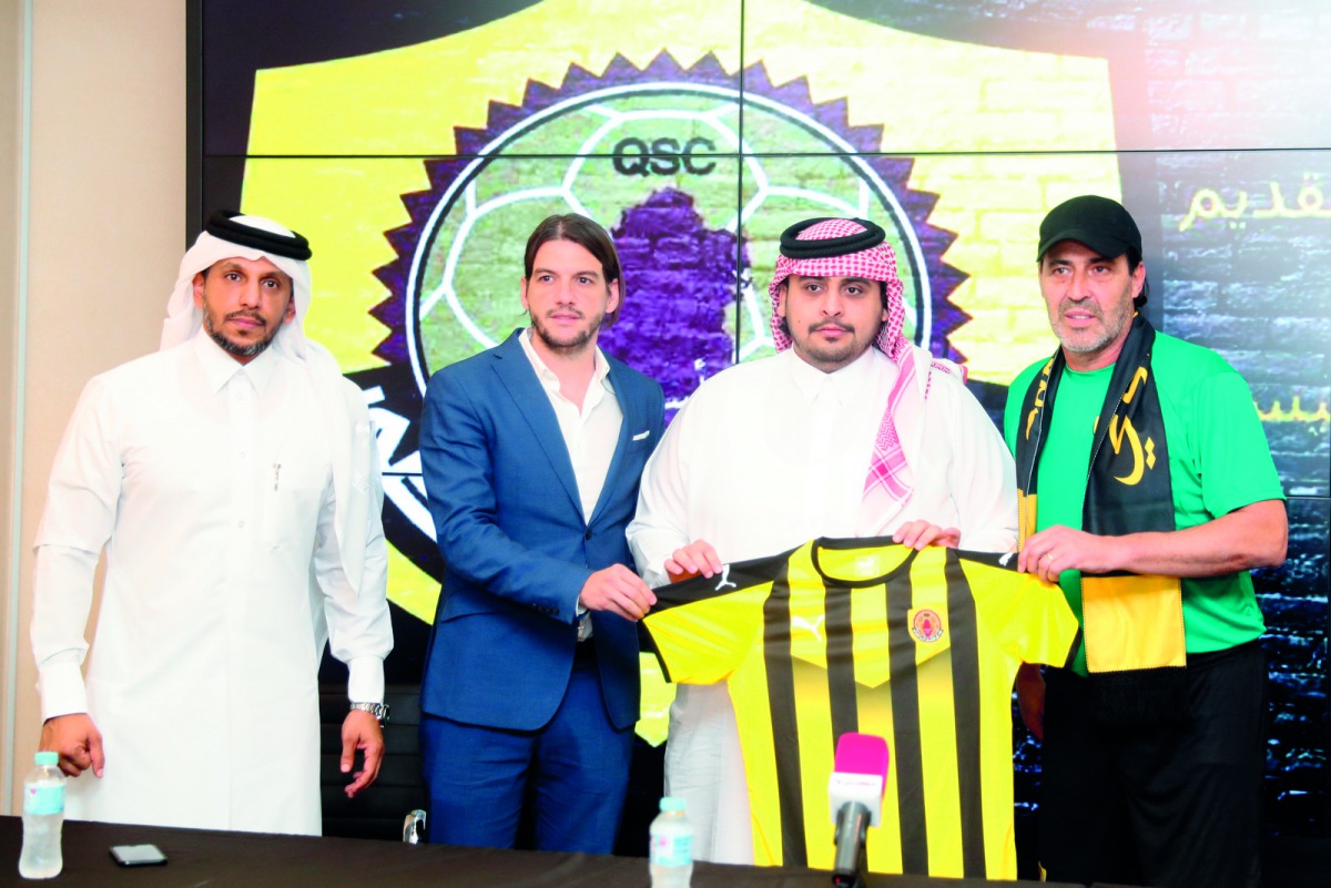 Sergio Batista (right) poses with officials during his unveiling as new Qatar SC coach.
