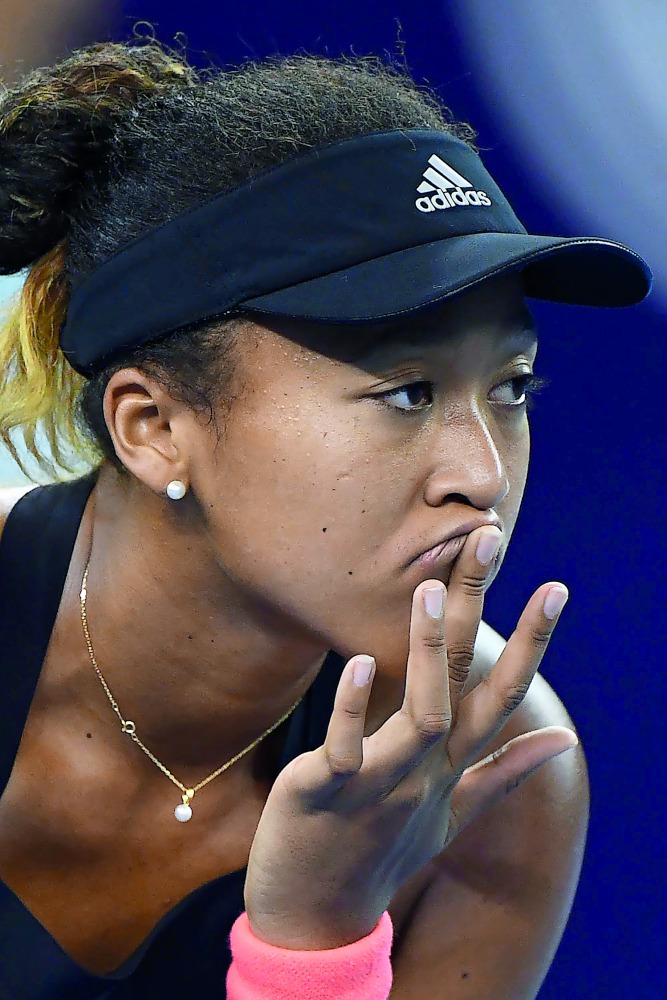 Naomi Osaka of Japan waits to receive a serve during her women's singles first round match against Zarina Diyas of Kazakhstan at the China Open tennis tournament in Beijing on October 1, 2018. AFP / Greg Baker

