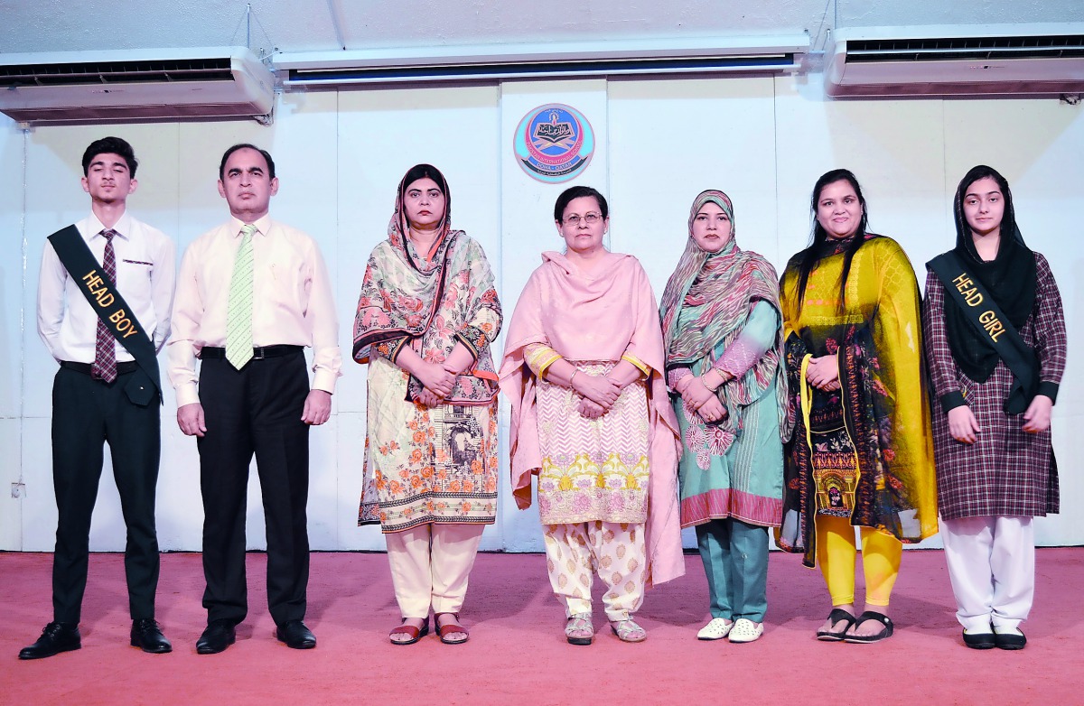 Nargis Raza Otho, Principal of PISQ (centre), with other officials and the newly-elected Head Boy and Head Girl at the campus of the school.