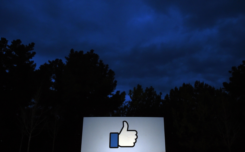 A lit Like sign is seen at the entrance to Facebook corporate headquarters location in Menlo Park, California on March 21, 2018. AFP/Josh Edelson