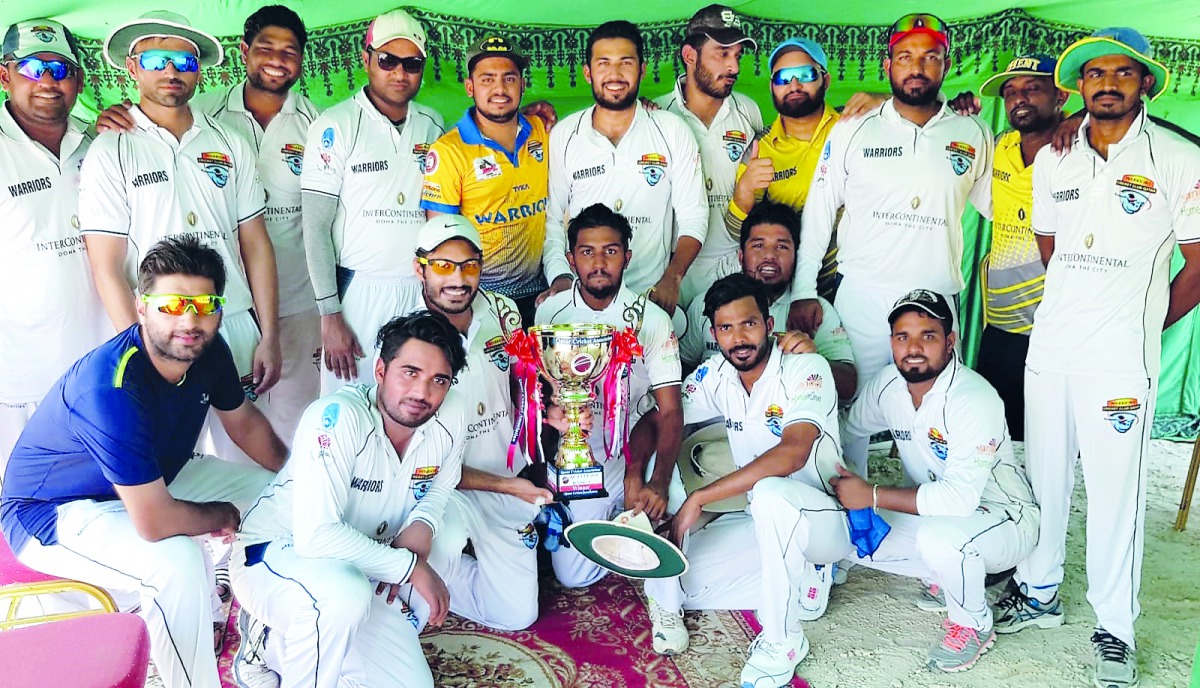 Warriors Club’s players pose with the trophy after winning the Division A final of QCA Twenty20 Cricket Tournament played in Doha recently.