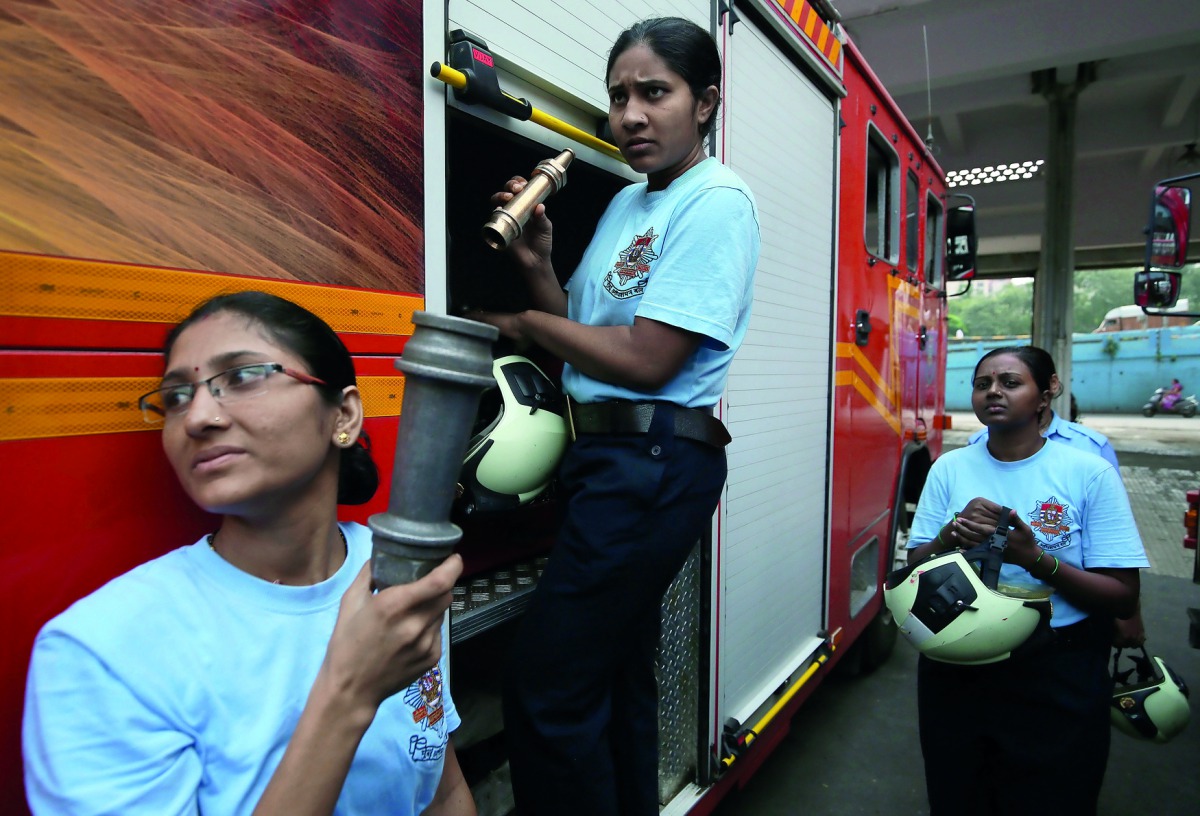 Female firefighters unload the firefighting equipment from a fire engine before a drill at a fire station in Mumbai, India, October 4, 2018. Reuters/Francis Mascarenhas