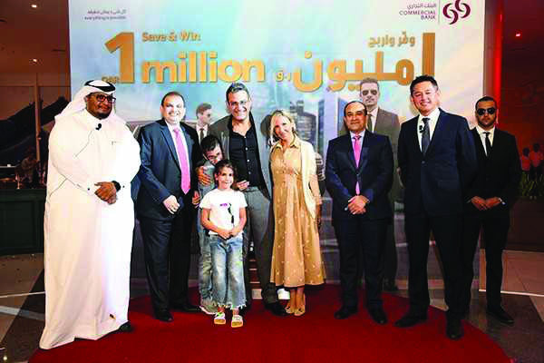 Joseph Abraham (third right), Commercial Bank CEO; Amit Sah (second left), Head of Retail Banking at Commercial Bank, and other bank officials with Raymond Frangieh, grand prize winner of Commercial Bank’s Save & Win campaign, and family. 
