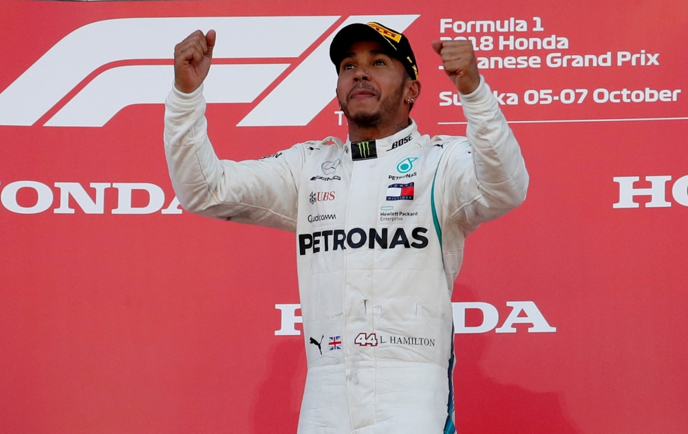 Mercedes' Lewis Hamilton celebrates winning the race on the podium REUTERS/Issei Kato
