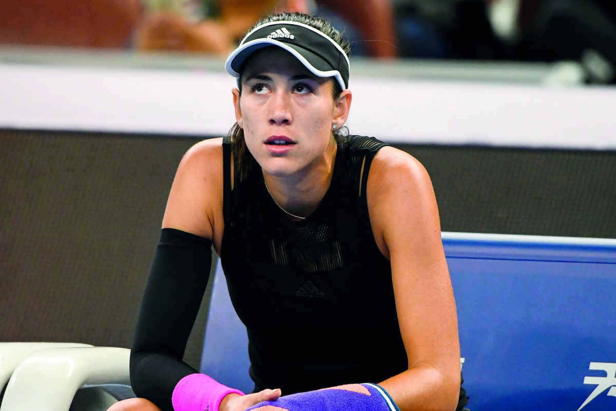 Garbine Muguruza of Spain concentrates during a break at her women's singles second round match against Aryna Sabalenka of Belarus at the China Open tennis tournament in Beijing on October 2, 2018.  AFP / Fred Dufour

