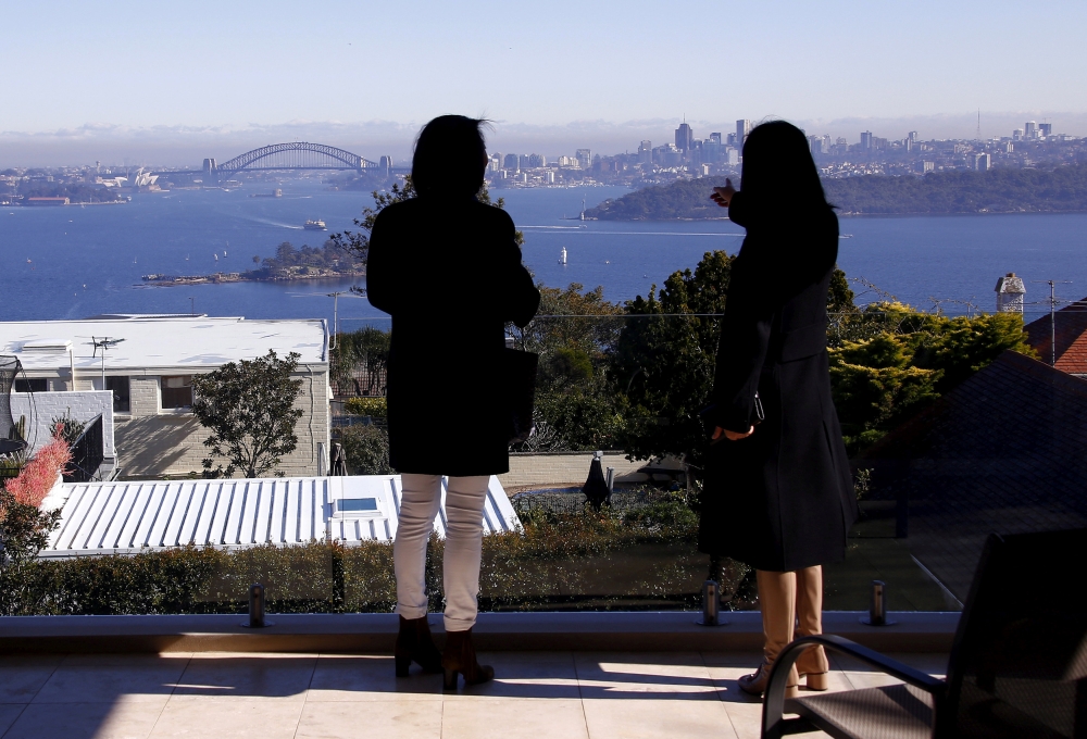 File photo: The Sydney Opera House and Harbour Bridge can be seen behind real estate agent and a potential buyer from Shanghai, during an inspection of a property for sale in the Sydney suburb of Vaucluse, Australia, July 11, 2015. Reuters/David Gray/File