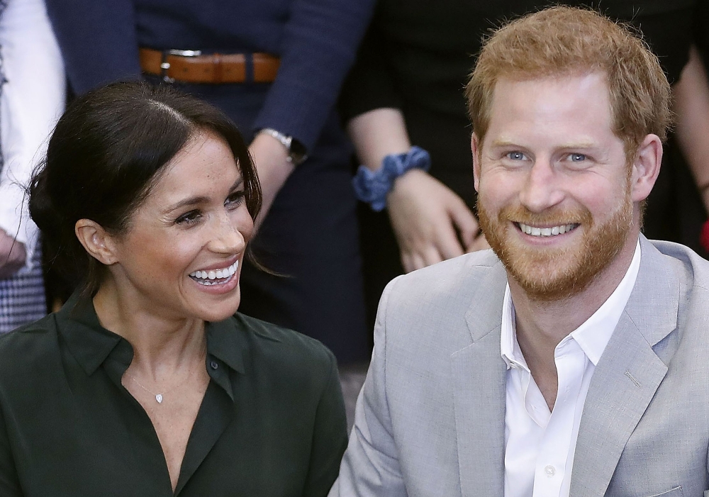 In this file photo taken on October 03, 2018 Britain's Prince Harry, Duke of Sussex (R) and Britain's Meghan, Duchess of Sussex (L) meet with young people on a visit to Joff Youth Centre in Peacehaven in East Sussex, southern England, on October 3, 2018. 