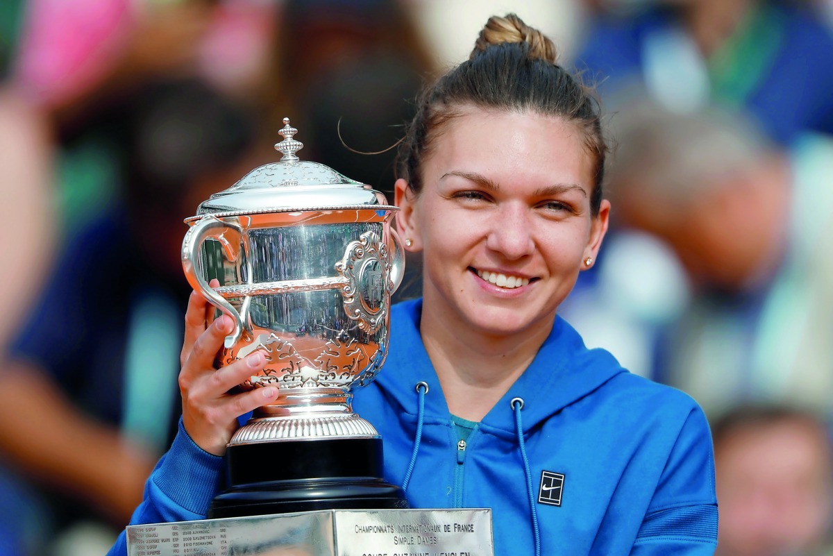 Romania’s Simona Halep celebrates with the French Open trophy at Roland Garros, Paris, France - June 9, 2018. Reuters/Charles Platiau