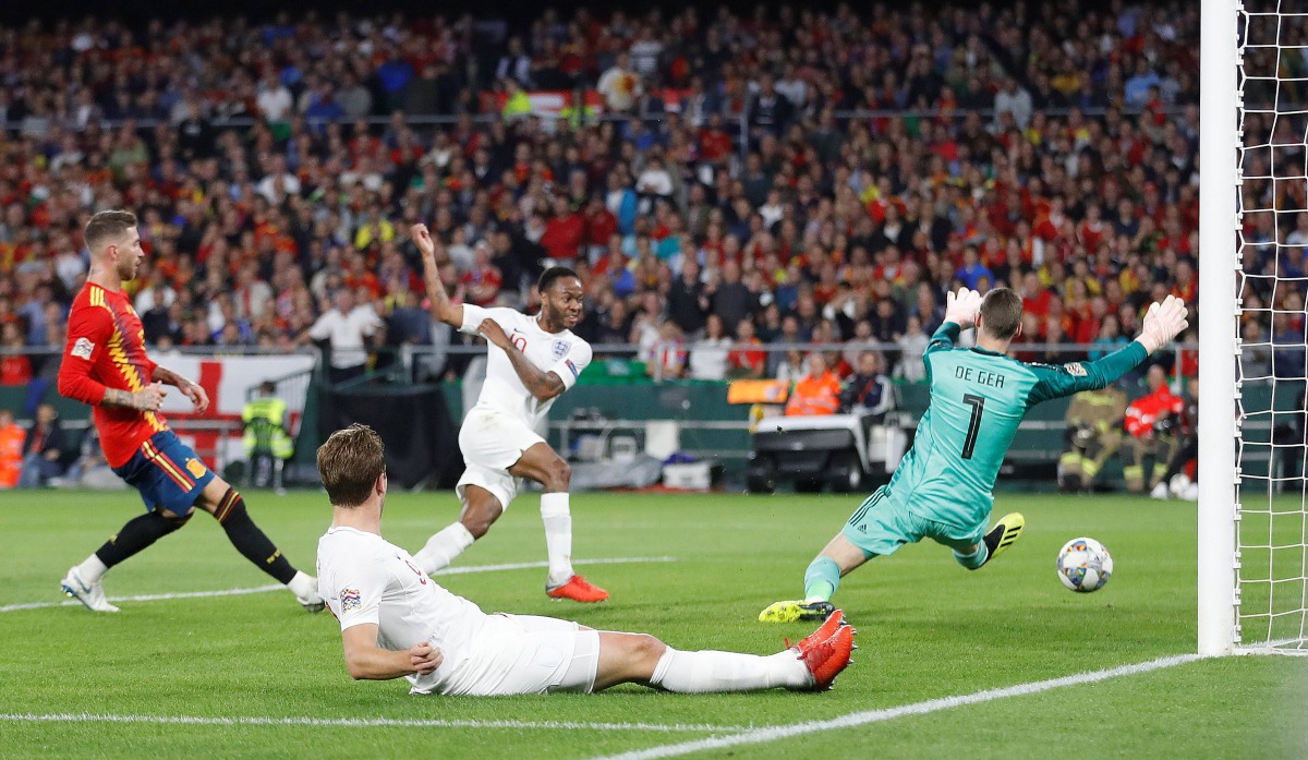 England's Raheem Sterling scores their third goal past Spain's David De Gea. (Action Images via Reuters/Carl Recine)  

