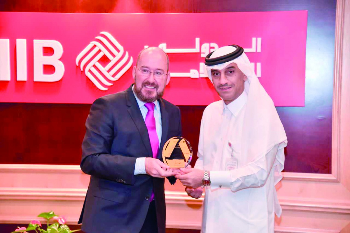 QIIB Deputy CEO, Jamal Abdulla Al Jamal (right) receiving the award from  Andreas Scheer, Head (Loan Capital Markets) FI Frankfurt.