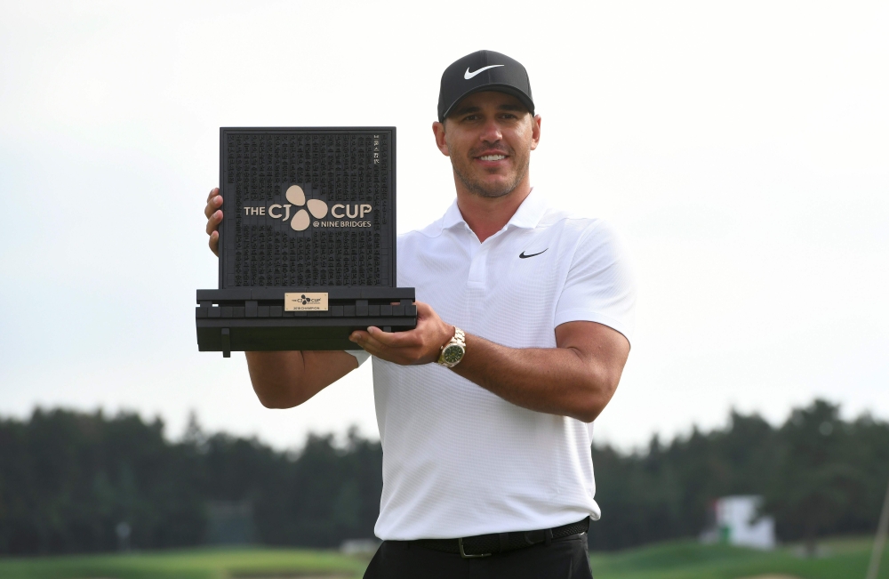 Brooks Koepka of the US poses with the trophy during the awards ceremony after winning the CJ Cup golf tournament at Nine Bridges golf club in Jeju Island on October 21, 2018. AFP / Jung Yeon-je