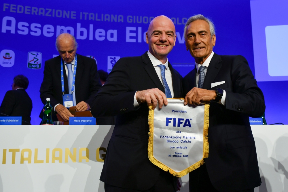 :New President of the Italian Football Federation (FIGC), Gabriele Gravina (R) poses with FIFA President, Gianni Infantino following the vote during the elective assembly of the FIGC on October 22, 2018 at the Hilton hotel of Rome's Fiumicino airport. / A