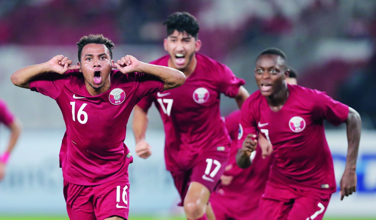 Qatar’s Hashim Ali (left) celebrates with team-mates after scoring against hosts Indonesia their AFC U-19 Championship match against hosts Indonesia at the Gelora Bung Karno Stadium in Jakarta yesterday.
