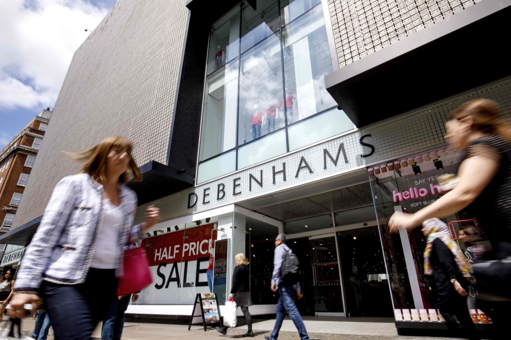 (FILES) In this file photo taken on June 19, 2018 Shoppers walk past a Debenhams shop in Oxford Street, central London. AFP / Tolga Akmen