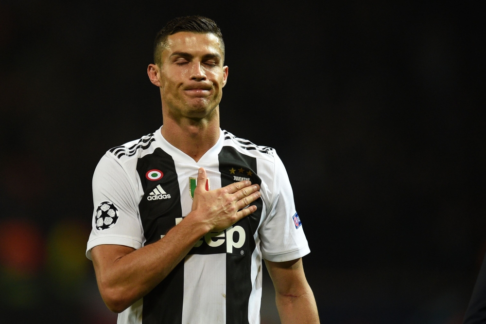 Juventus' Portuguese striker Cristiano Ronaldo gestures to supporters on the pitch after the Champions League group H football match between Manchester United and Juventus at Old Trafford in Manchester, north west England, on October 23, 2018.  / AFP / Ol