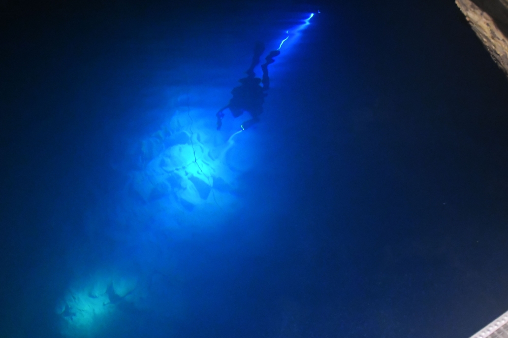 A member of a group of hobby divers, speleologists and accompanying staff descends into the water at the entrance tunnel during an exploration of the Janos Molnar cave system on October 2, 2018 under the Buda Hill in Budapest. AFP / ATTILA KISBENEDEK