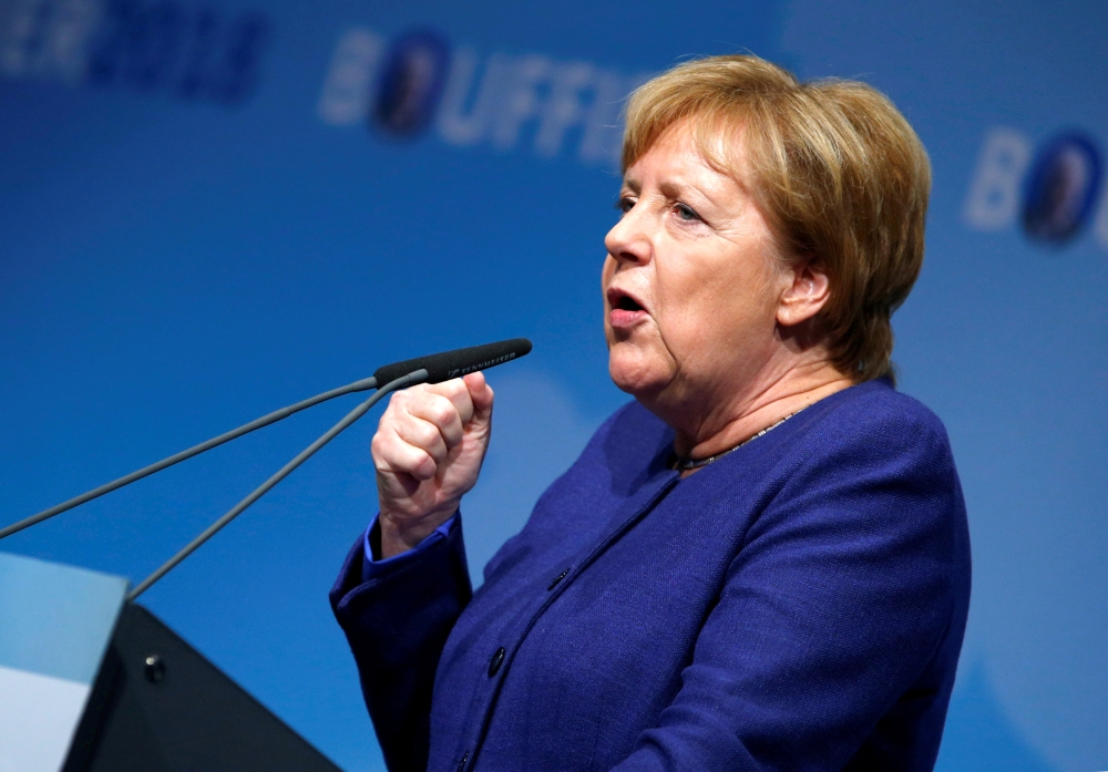 FILE PHOTO: German Chancellor Angela Merkel speaks during her Christian Democratic Union (CDU) party colleague and Hesse State Prime Minister Volker Bouffier's campaign rally for the upcoming state election Dieburg, Germany, October 23, 2018. REUTERS/Ralp