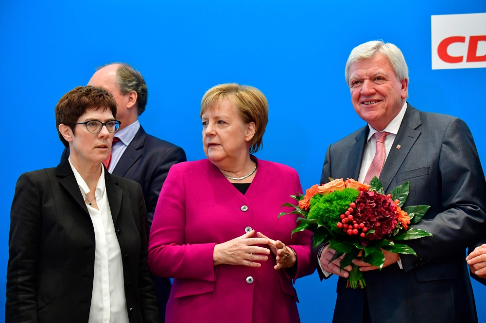 German Chancellor and leader of the Christian Democratic Union (CDU) Angela Merkel (C) stands with Secretary General of the Christian Democratic Union (CDU) Annegret Kramp-Karrenbauer (L) and Hesse's State Premier and Deputy Chairman of the Christian Demo