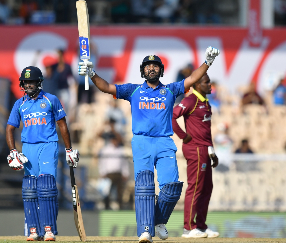 India cricketer Rohit Sharma celebrates after scoring a century (100 runs) during the fourth one day international (ODI) cricket match between India and West Indies at the Brabourne Stadium in Mumbai on October 29, 2018. (AFP / PUNIT PARANJPE)