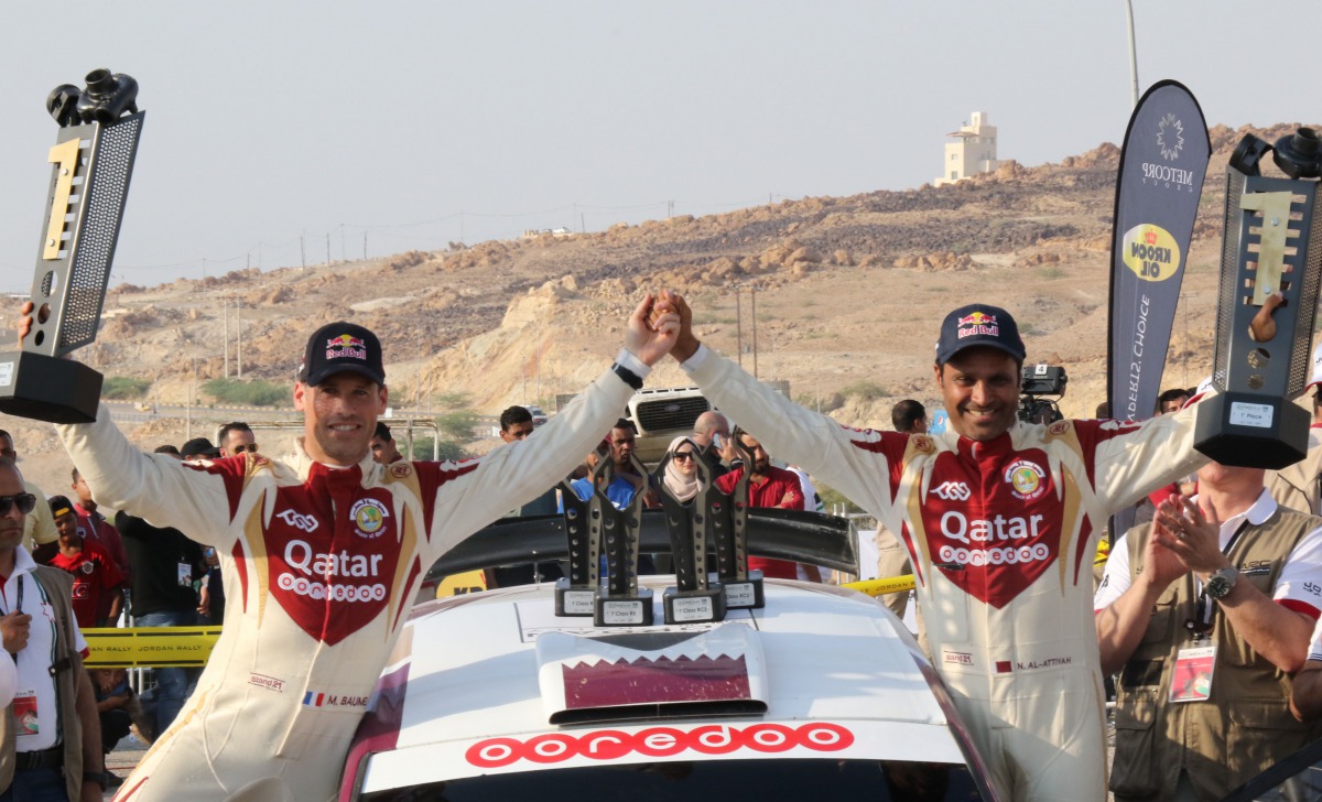 Qatari driver Nasser Saleh Al Attiyah (right) and his navigator Matthieu Baumel celebrate after winning an earlier stage of the  FIA Middle East Rally Championship  in Jordan in this file photo. 