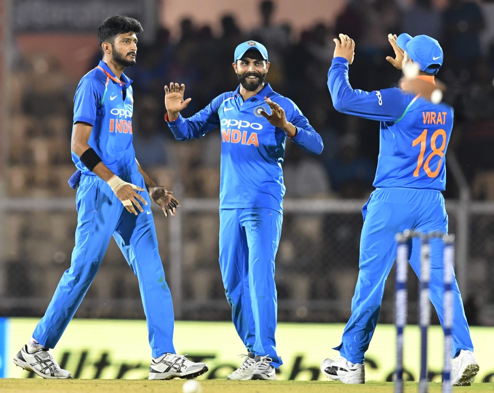Indian bowler Khaleel Ahmed (L) celebrates with teammates Ravindra Jadeja (C) and captain Virat Kohli after the wicket of West Indies batsman Shimron Hetmyer during the fourth one day international (ODI) cricket match between India and West Indies at the 