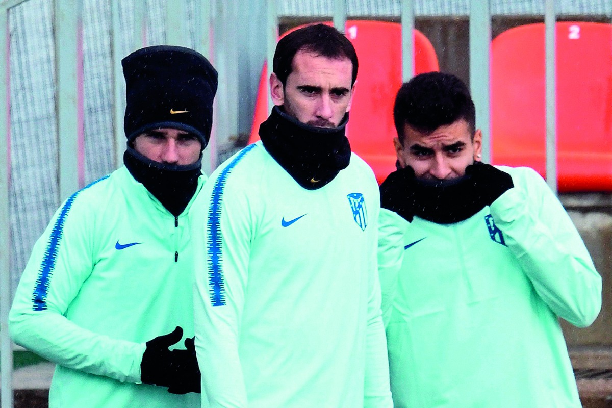 Atletico Madrid's French forward Antoine Griezmann, Atletico Madrid's Uruguayan defender Diego Godin and Atletico Madrid's Argentinian forward Angel Correa attend a training session at the Ciudad Deportiva Wanda training ground in Madrid on November 5, 20