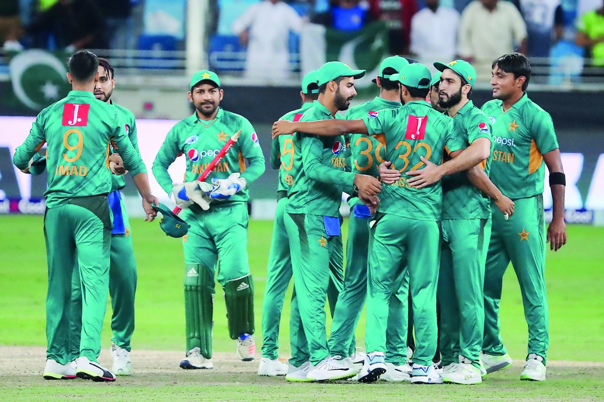 Pakistan's team players celebrate at the end of the T20 cricket match between Pakistan and New Zealand at the Dubai Cricket Stadium in Dubai on November 4, 2018. AFP / Karim Sahib

