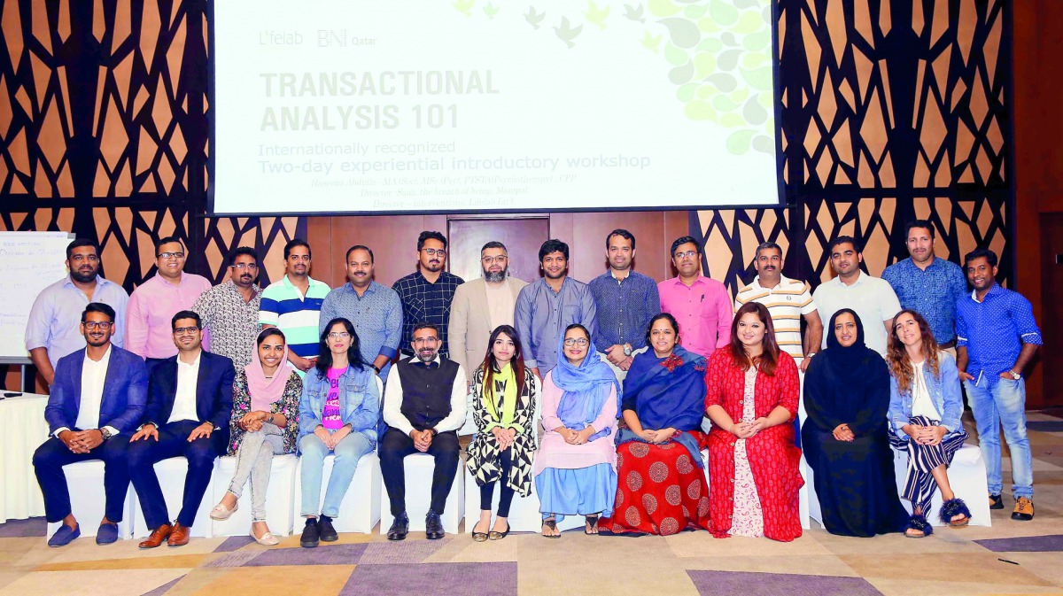The participants of the workshop pose for a group photo with officials. 