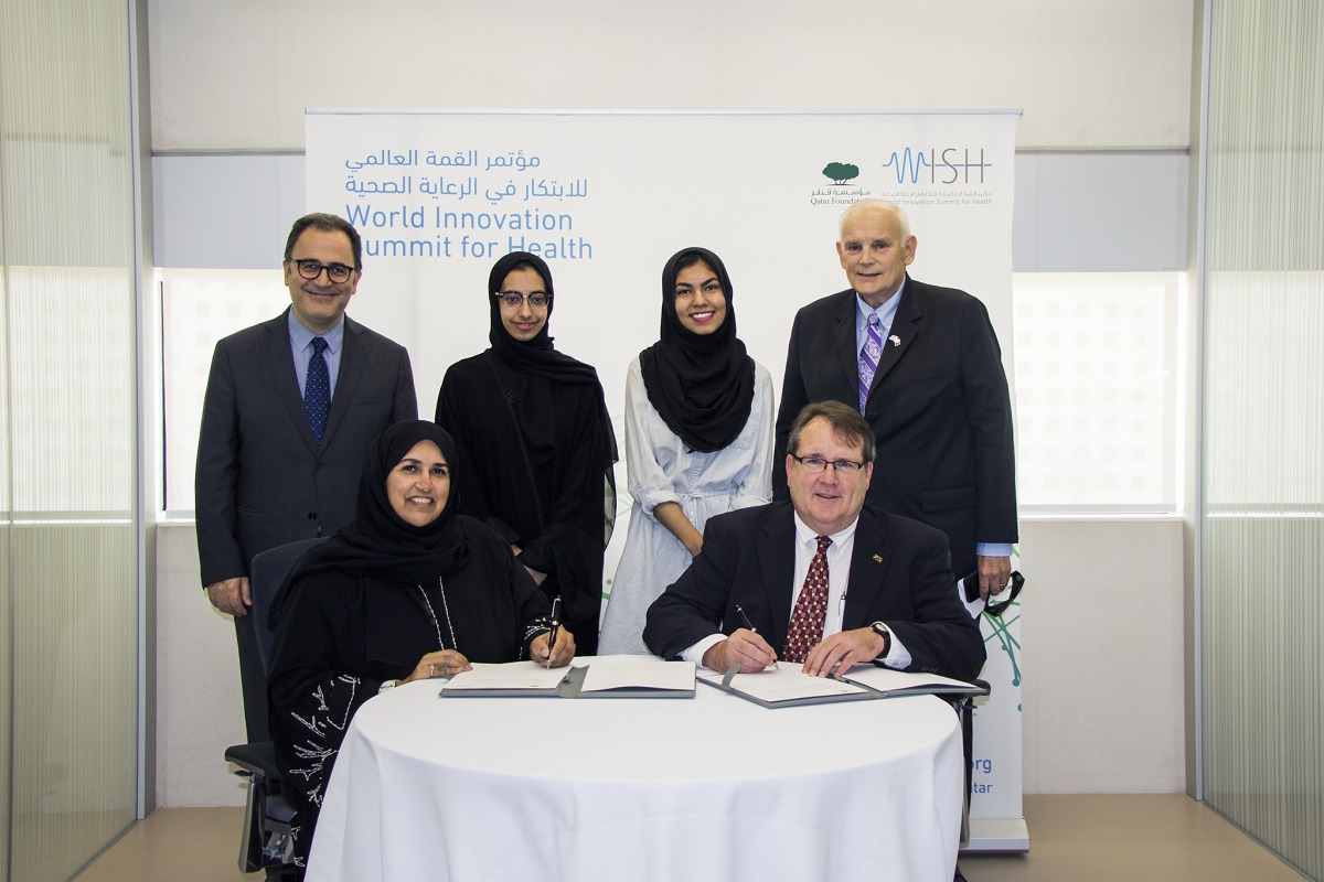 Officials of WISH and The Carter Center signing the agreement in the presence of the Deans from Georgetown University in Qatar and Northwestern University in Qatar, as well as the participating students.