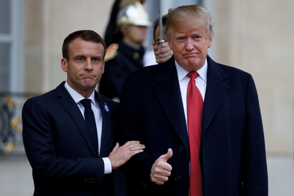 French President Emmanuel Macron welcomes U.S. President Donald Trump at the Elysee Palace on the eve of the commemoration ceremony for Armistice Day, 100 years after the end of the First World War, in Paris, France, November 10, 2018. REUTERS/Vincent Kes