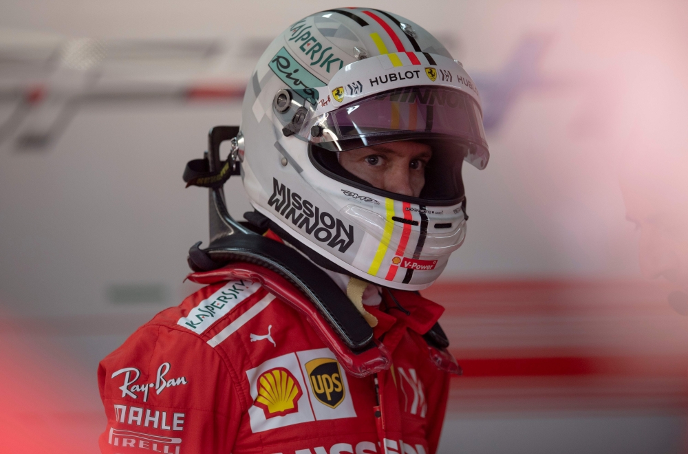 Ferrari's German driver Sebastian Vettel waits at the paddock to get back to his car during the second training session of the F1 Brazil Grand Prix at the Interlagos racetrack in Sao Paulo, Brazil on November 09, 2018. / AFP / Mauro Pimentel