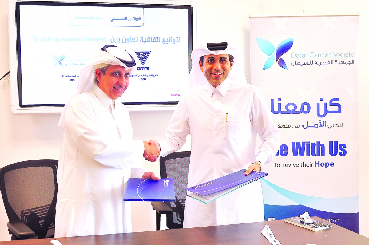 Dr Sheikh Khalid bin Jabor Al Thani, Chairman of QCS (left) and Dr Nasser Saqer Al Mohannadi, Founding President of  Qatar Triathlon Club exchanging documents after signing the MoU yesterday.  
Pic: Baher Amin / The Peninsula
