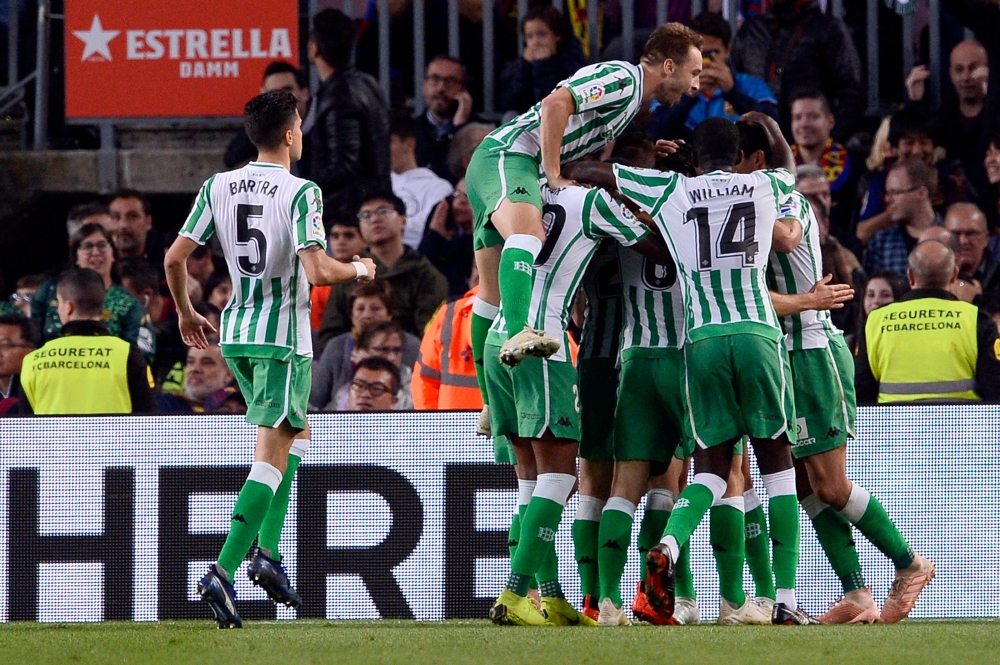 Betis players celebrate a goal during the Spanish league football match between FC Barcelona and Real Betis at the Camp Nou stadium in Barcelona on November 11, 2018. / AFP / Josep LAGO