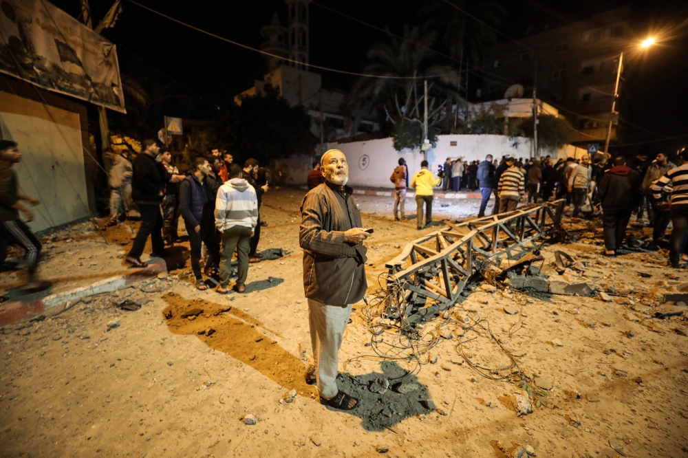 Residents inspect the damage after the Israeli airstrikes hit the Hamas-run Al-Aqsa TV in Gaza on November 12, 2018. (Mustafa Hassona/Anadolu Agency)
