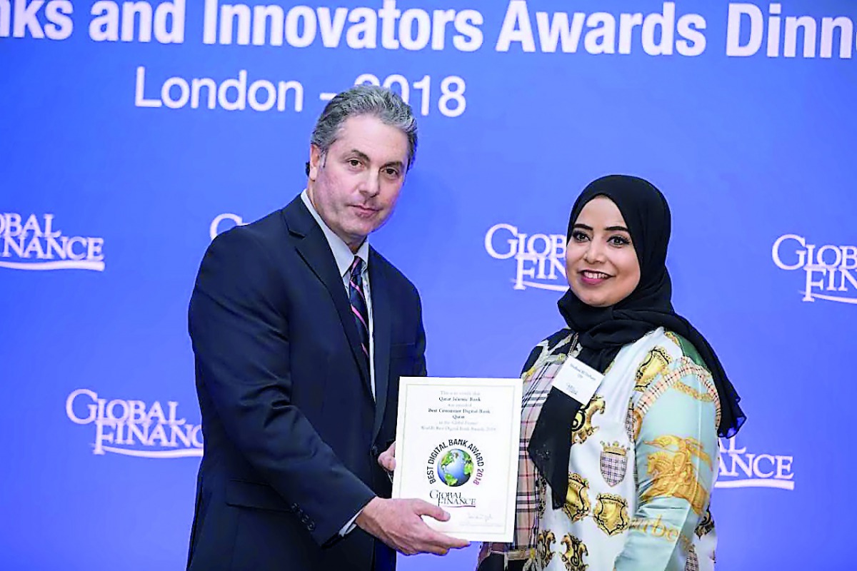 Mashaal Al Derham (right), Head of Corporate Communications & Quality Assurance at QIB, receiving the award.