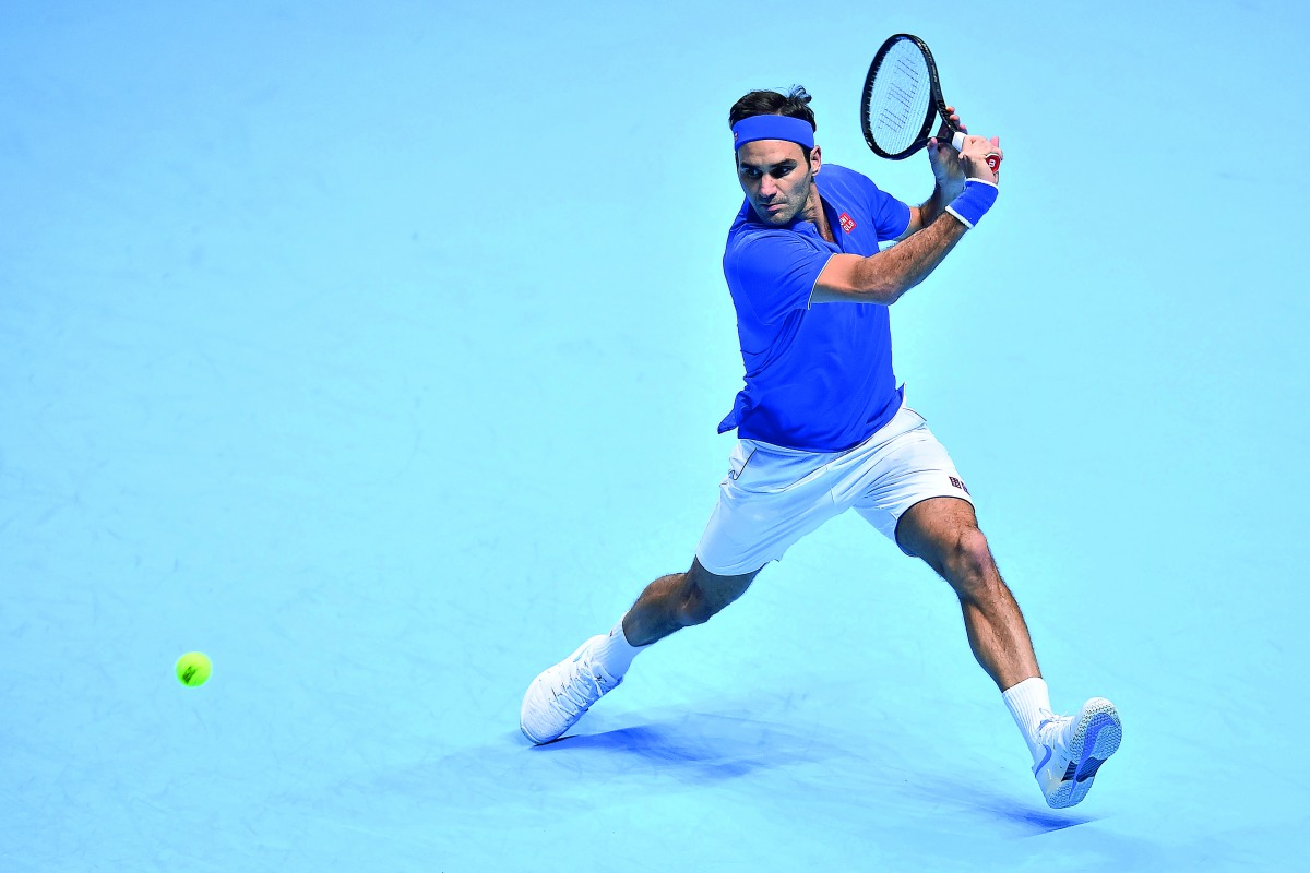 Switzerland's Roger Federer returns against Austria's Dominic Thiem during their men's singles round-robin match on day three of the ATP World Tour Finals tennis tournament at the O2 Arena in London on November 13, 2018. AFP / Glyn Kirk