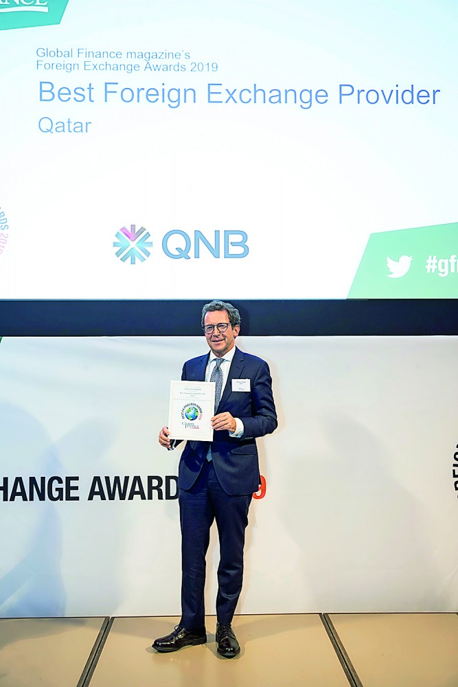 A QNB official with the award.