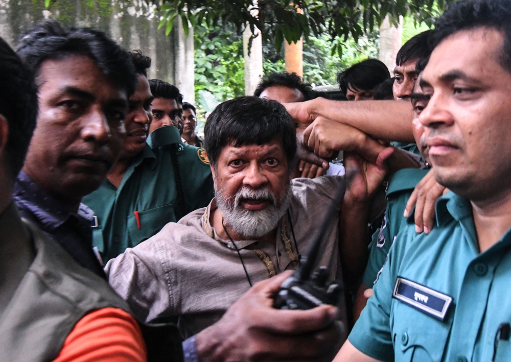 In this file photo taken on August 6, 2018 activist and photographer Shahidul Alam arrives surrounded by policemen for an appearance in court in Dhaka.  AFP / Munir Uz Zaman
 