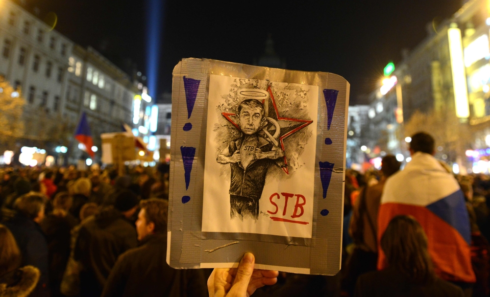 A protester holds up a sign depicting Czech Prime Minister Andrej Babis during a rally to protest against Babis, following a scandal of having managed subsidy fraud, on November 15, 2018 at the Wenceslas Square in Prague. AFP / Michal Cizek 