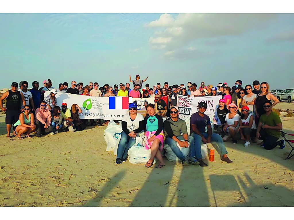 Volunteers after cleaning at Al Zubara beach. 