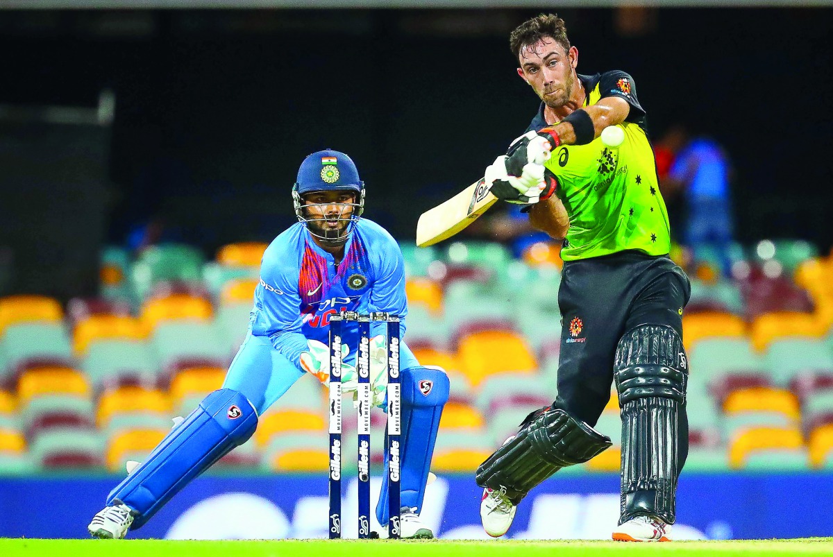 Australia's batsman Glenn Maxwell (R) hits a shot off the bowling of India's Krunal Pandya during the T20 international cricket match between Australia and India in Brisbane on November 21, 2018. AFP / Patrick Hamilton