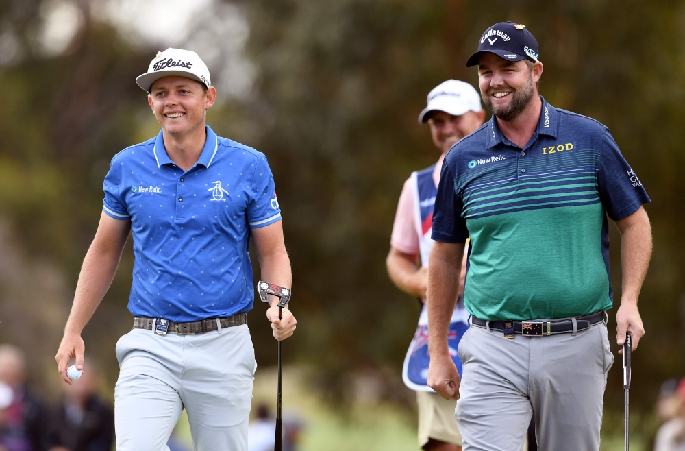 Cameron Smith (L) and Marc Leishmann of Australia share a light moment on the first day of the World Cup of Golf at the Metropolitan Golf Club in Melbourne on November 22, 2018. AFP / William West 