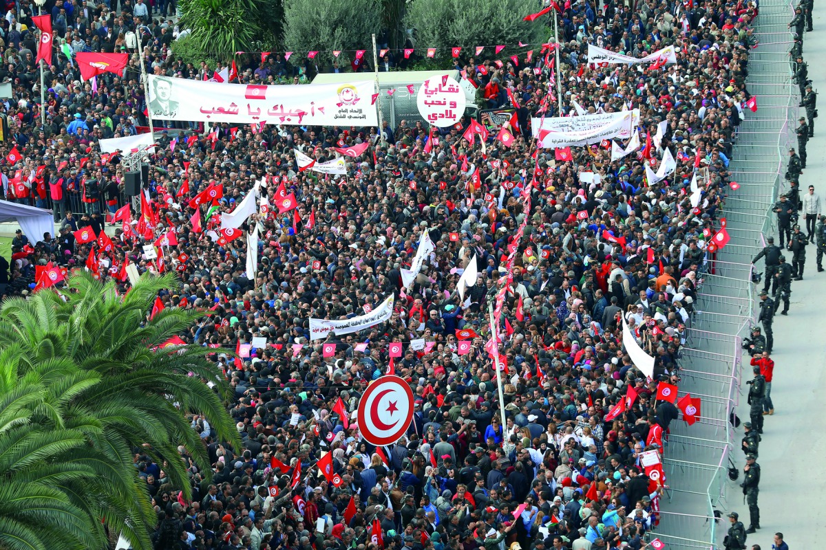 Tunisian civil servants and workers gather during a protest held for wage increase by Tunisian General Labour Union (UGTT) in Tunis, yesterday.