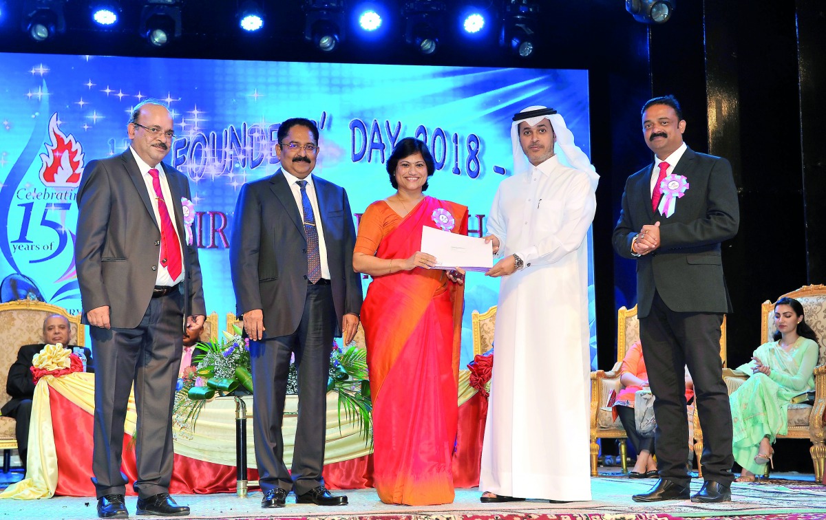 Dr. Khalid bin Mubarak Al-Shafi (second right), the Editor-in-Chief of The Peninsula and the Chief Guest of the 15th Founder’s Day celebrations of Birla Public School (BPS), honours Anu Thomas, Headmistress, Primary Section at BPS, for her 10 years of ded