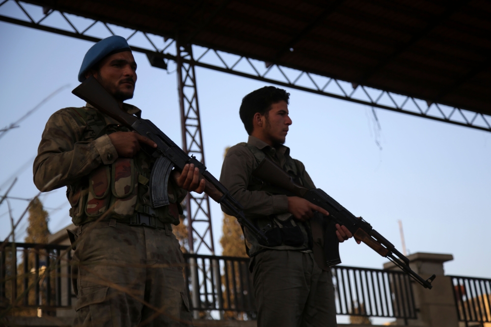 Turkey-backed Syrian fighters stand guard on November 19, 2018, in the northwestern Syrian city of Afrin.  AFP / Bakr ALKASEM
