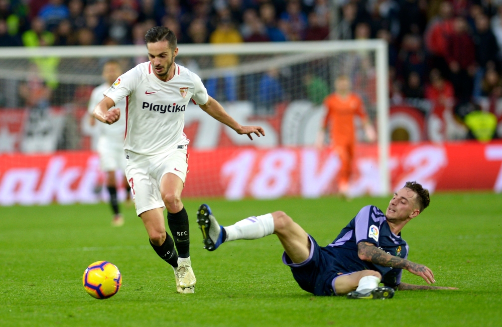 Sevilla's Spanish midfielder Pablo Sarabia (L) vies for the ball with Real Valladolid's Spanish defender Fernando Calero (R) during the Spanish league football match Sevilla FC against Real Valladolid FC at the Ramon Sanchez Pizjuan stadium in Sevilla on 
